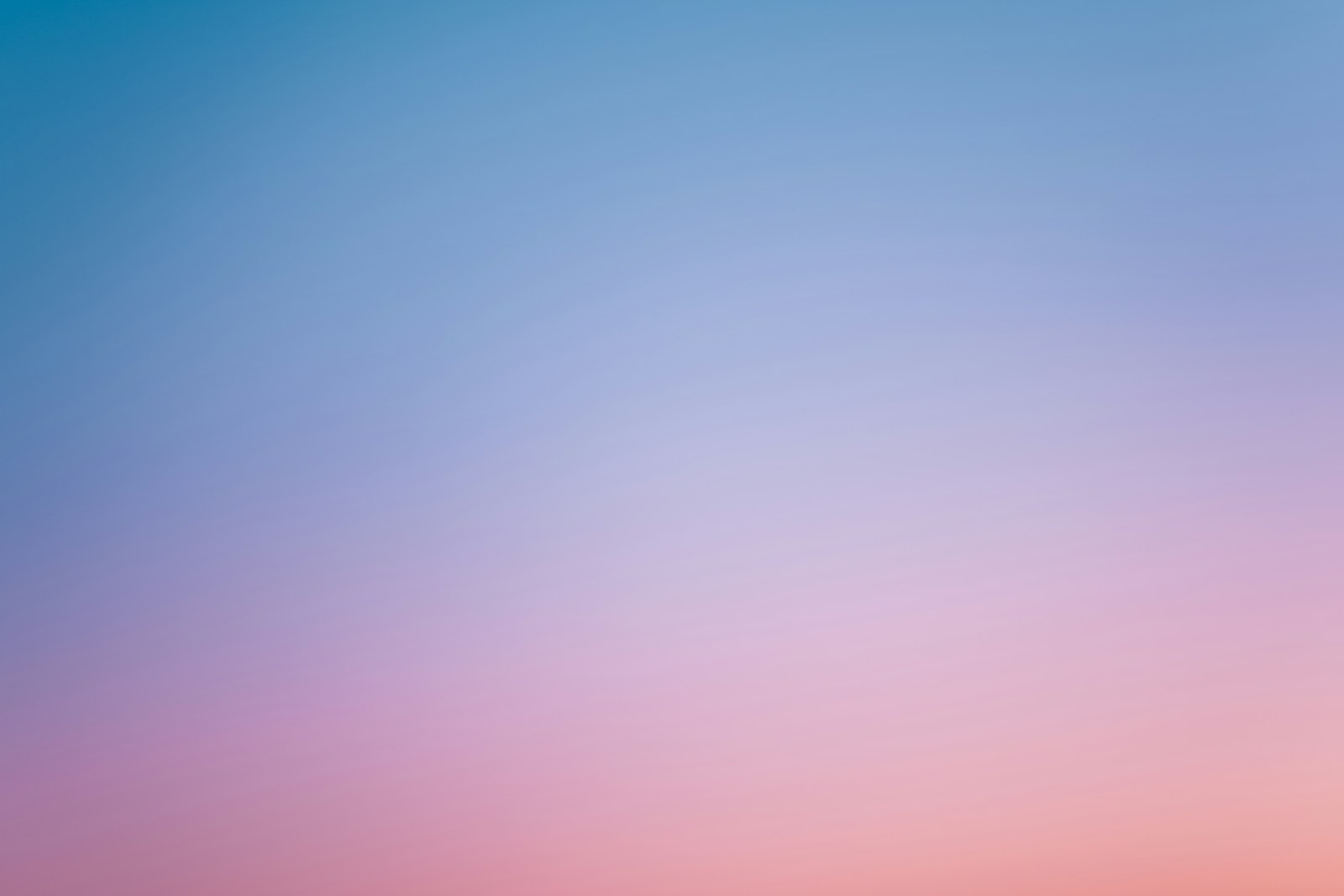 a pink and blue sky with a few clouds